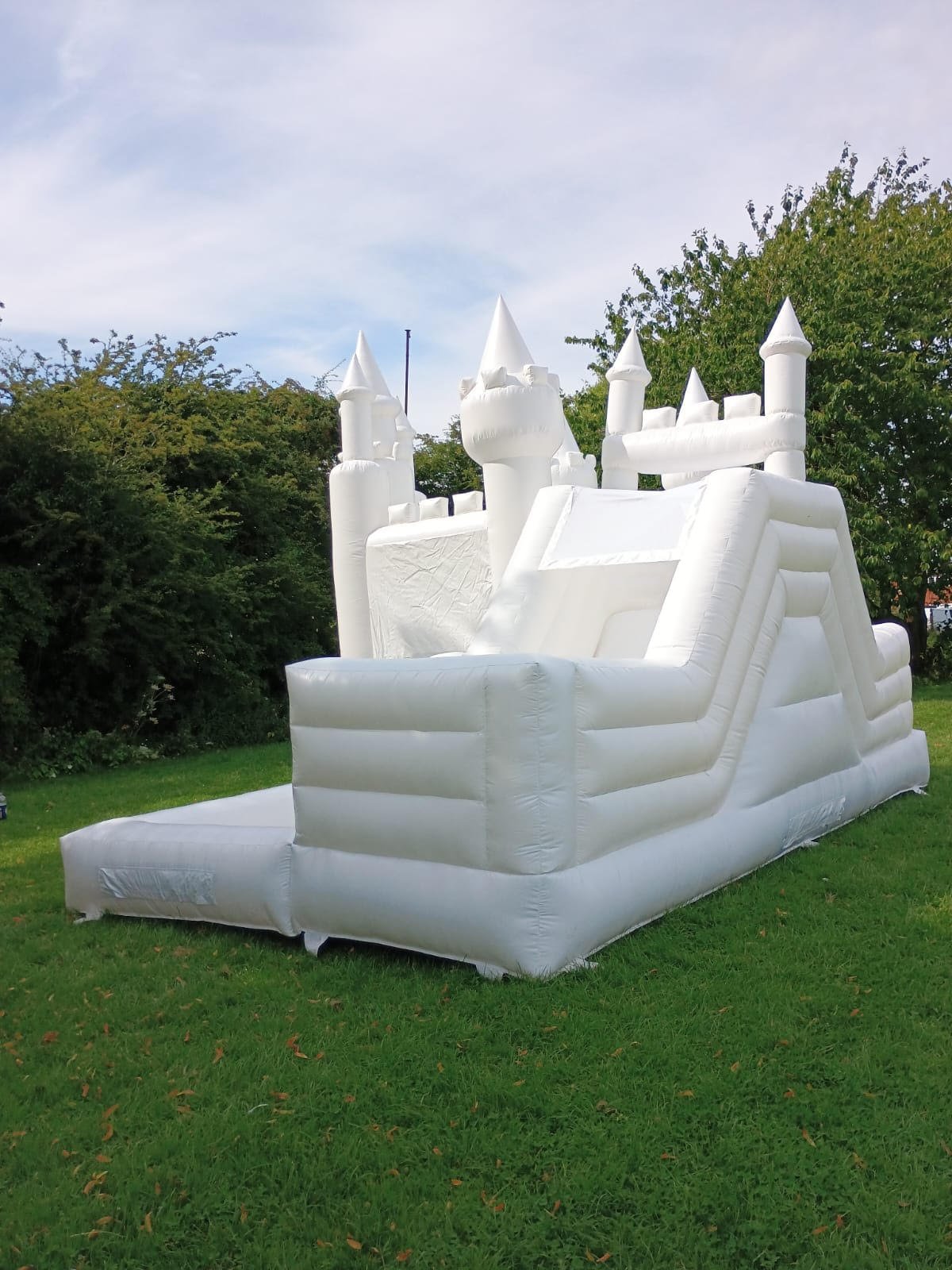 white bouncy castle with slide and ball pit for hire