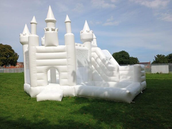 white bouncy castle with slide and ball pit for hire