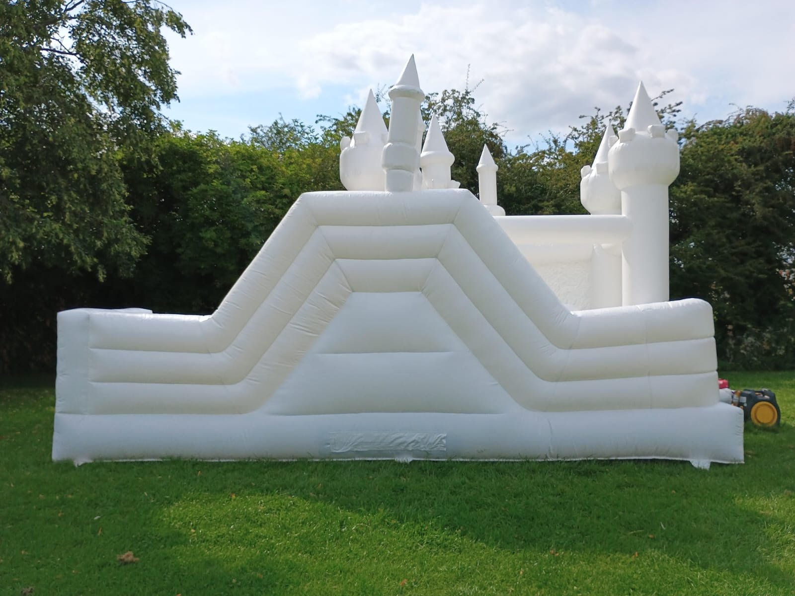 white bouncy castle with slide and ball pit for hire