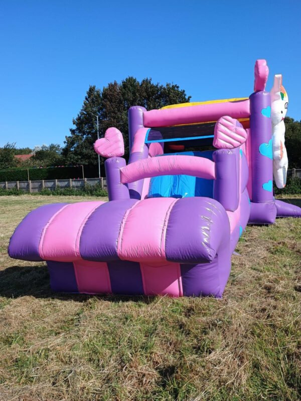 Unicorn bouncy castle with slide for hire