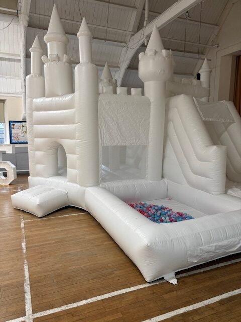 white bouncy castle with slide and ball pit to hire