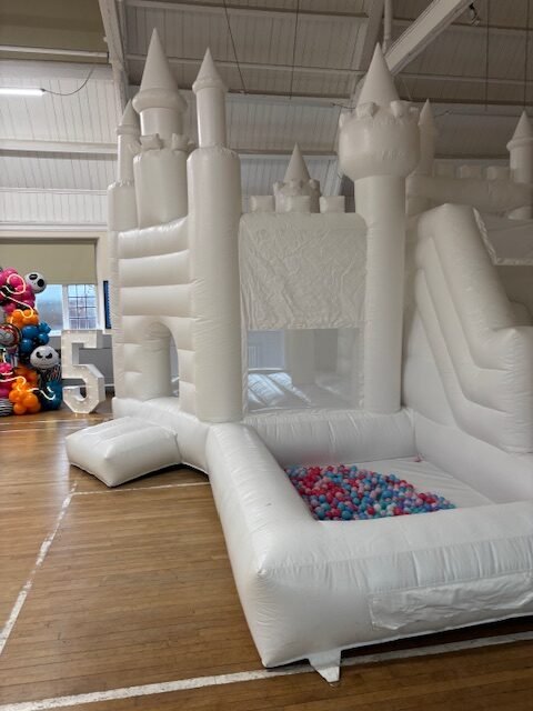 white bouncy castle with slide and ball pit to hire