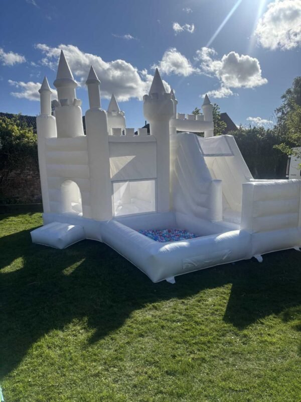 white bouncy castle with slide and ball pit