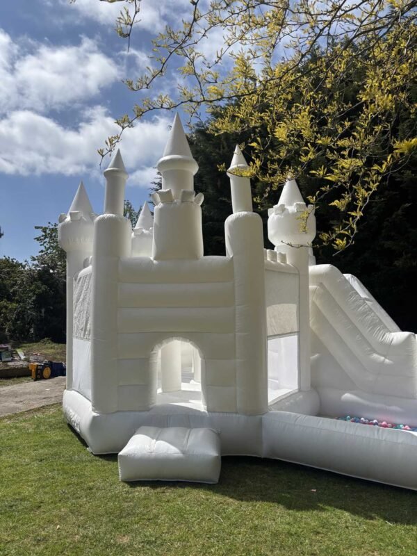 white bouncy castle with slide and ball pit