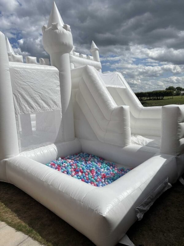 white bouncy castle with slide and ball pit