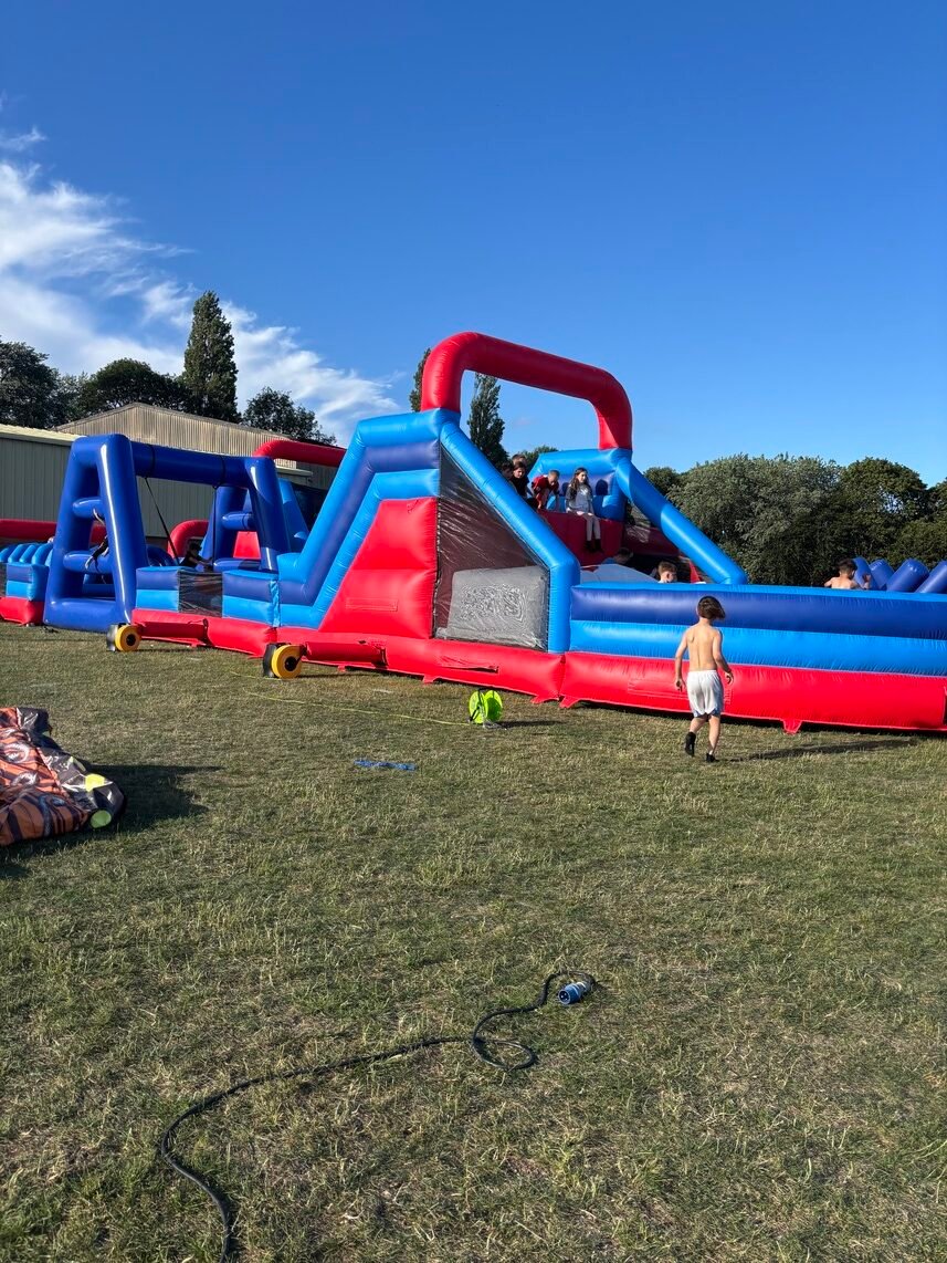 Obstacle course set up at outdoor event with participants