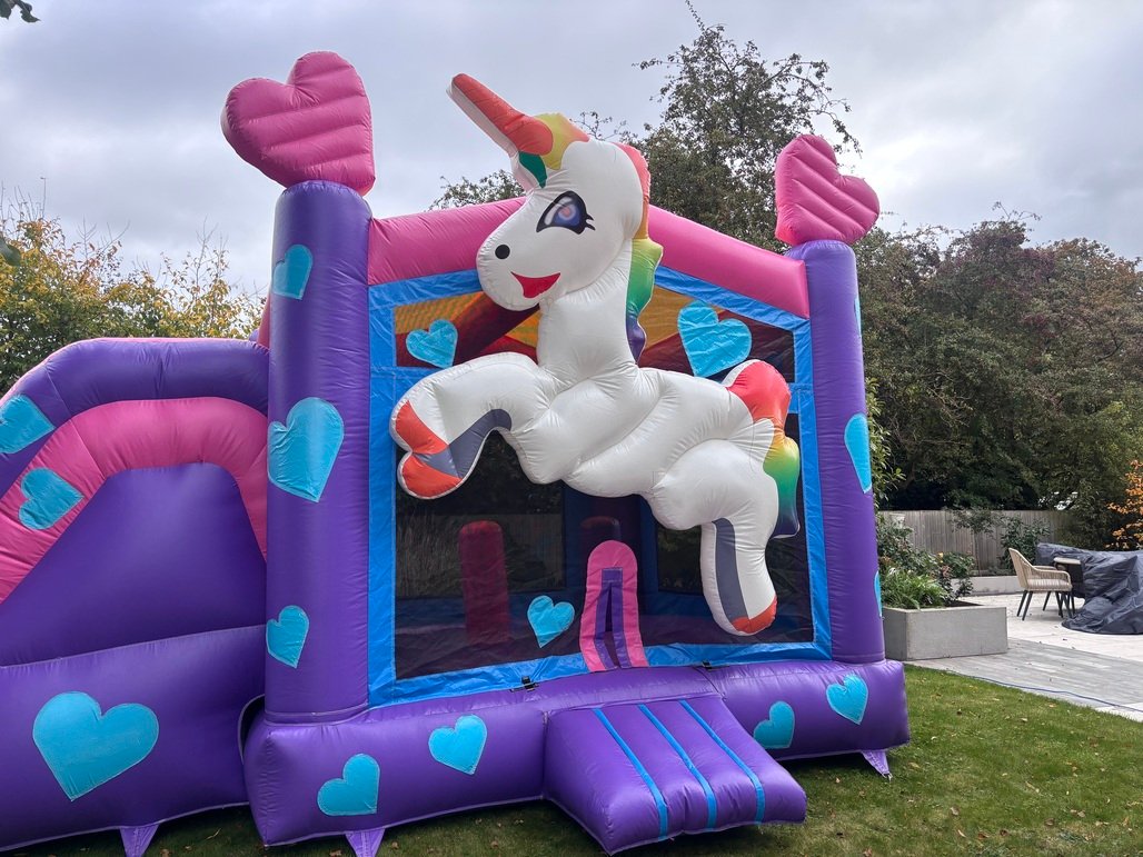 Front view of magical unicorn bouncy castle hire in Beverly