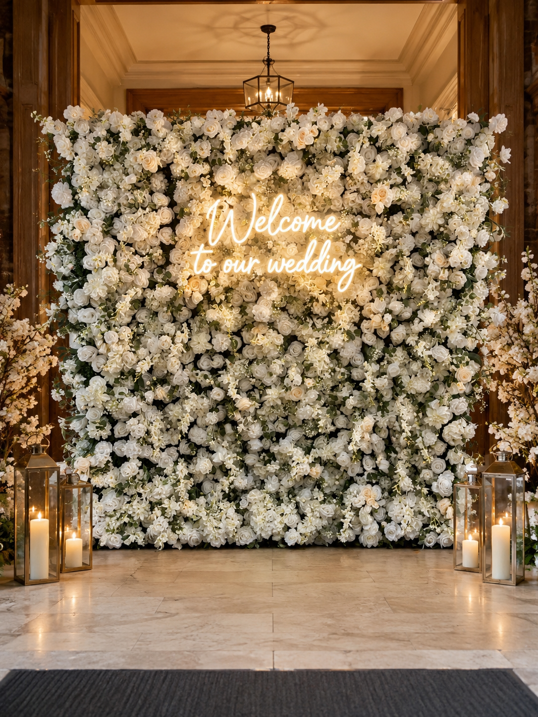 Luxury white rose flower wall styled with a Welcome to our wedding neon sign