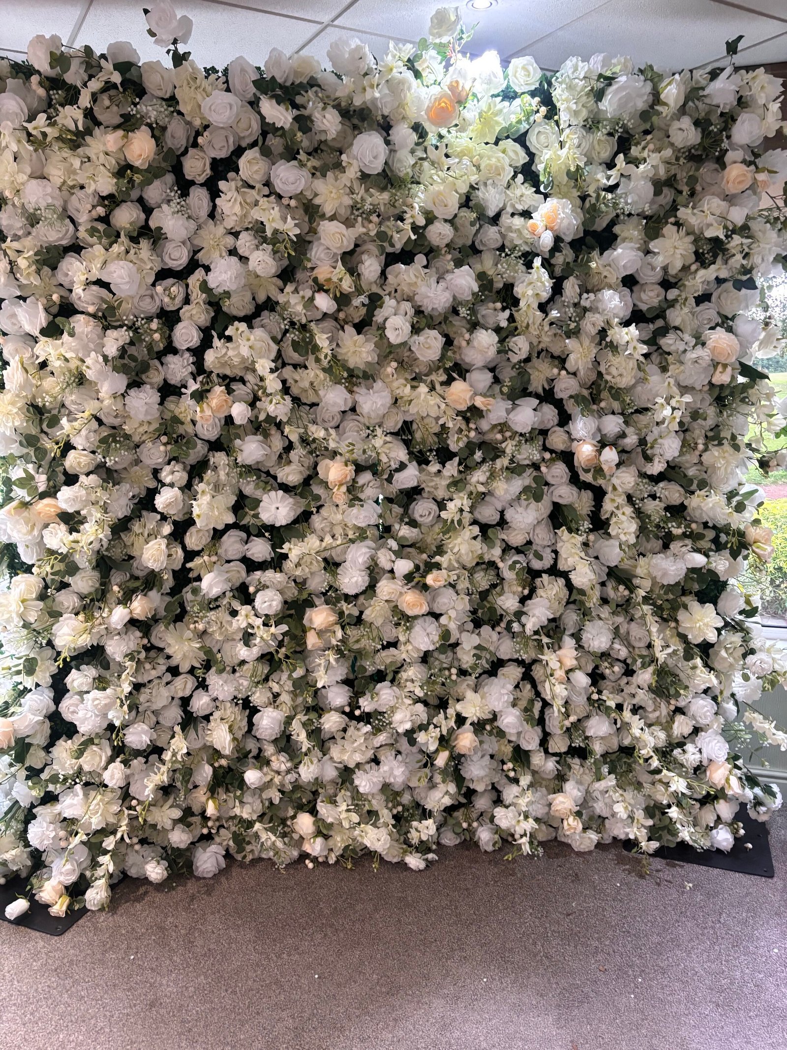 White flower wall backdrop included with the retro photo booth package