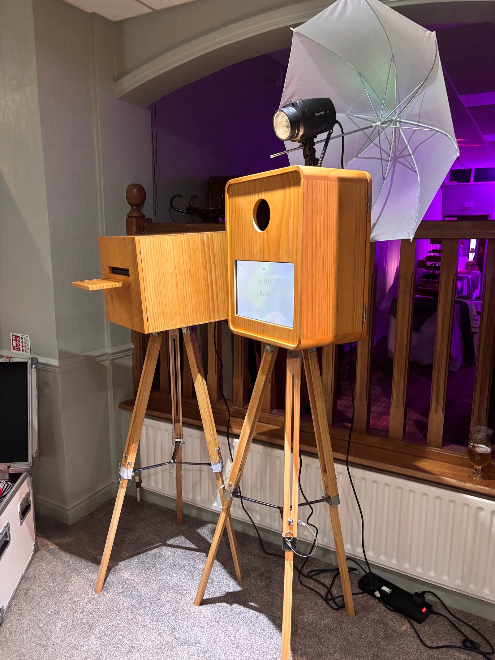 Vintage wooden photo booth and printer on tripod stands